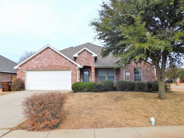 view of front of property featuring a garage and a front yard