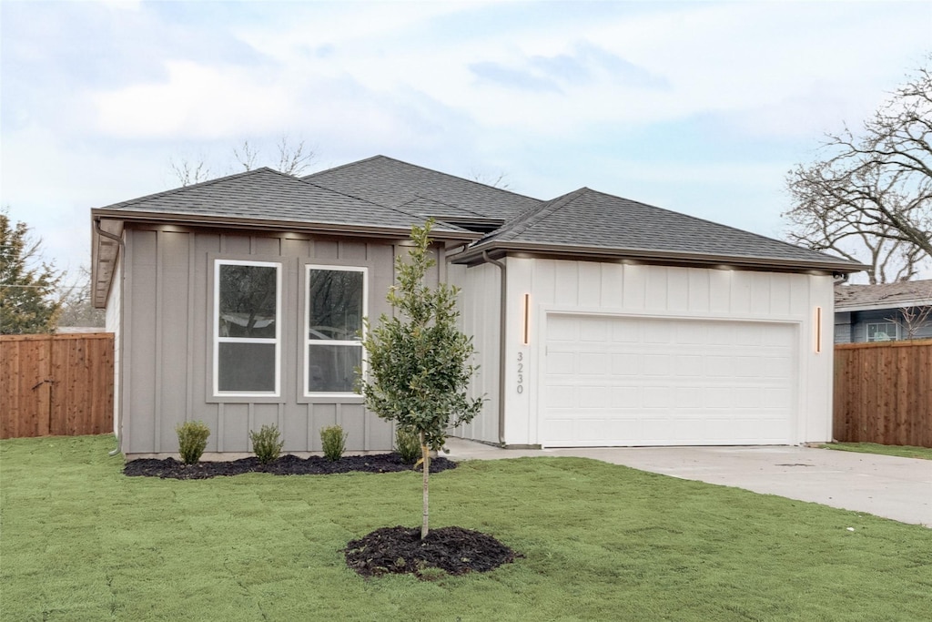 single story home featuring a garage and a front yard