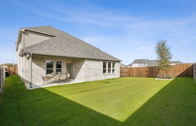 rear view of house featuring a patio and a lawn