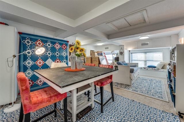 dining room featuring beamed ceiling and coffered ceiling