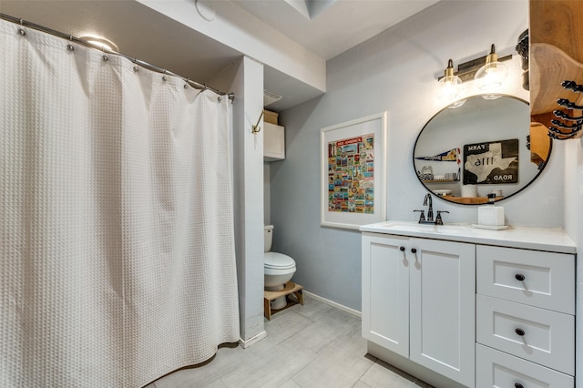 bathroom featuring vanity and toilet