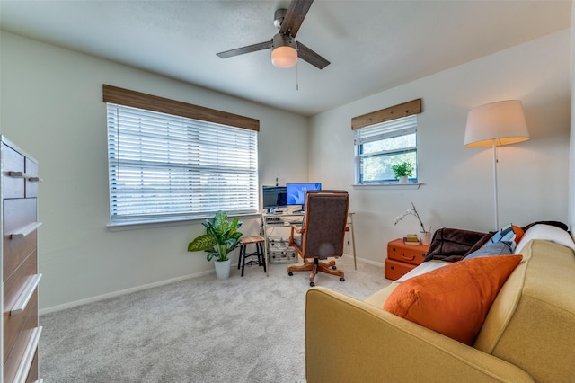 office space with ceiling fan and light colored carpet