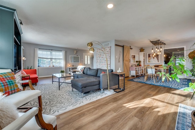 living room with wood-type flooring and a chandelier