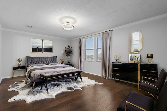 bedroom with dark wood-type flooring and ornamental molding