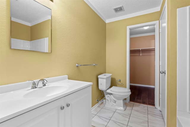 bathroom featuring vanity, toilet, a textured ceiling, and walk in shower