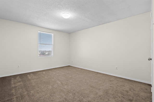 unfurnished room featuring a textured ceiling and carpet flooring