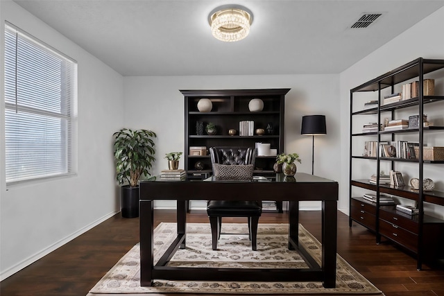 home office with dark hardwood / wood-style floors