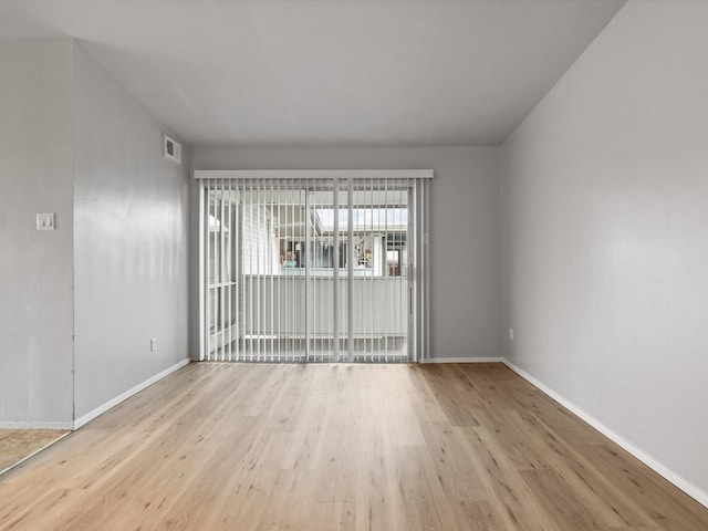 spare room with light wood-type flooring