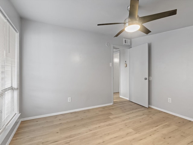 empty room with ceiling fan and light wood-type flooring