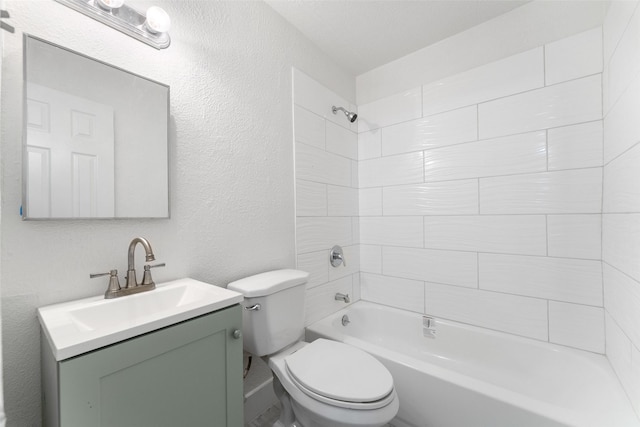 full bathroom featuring vanity, tiled shower / bath, and toilet