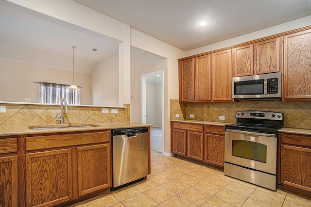 kitchen with sink, light tile patterned floors, hanging light fixtures, stainless steel appliances, and tasteful backsplash