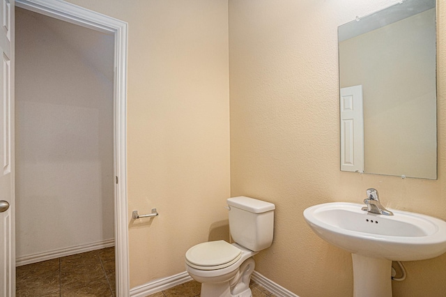 bathroom with tile patterned flooring and toilet