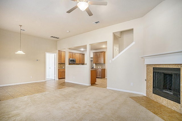 4216 Bridgestone Dr, Fort Worth, TX 76123 - unfurnished living room with light colored carpet, light tile patterned floors, ceiling fan, baseboards, and a fireplace