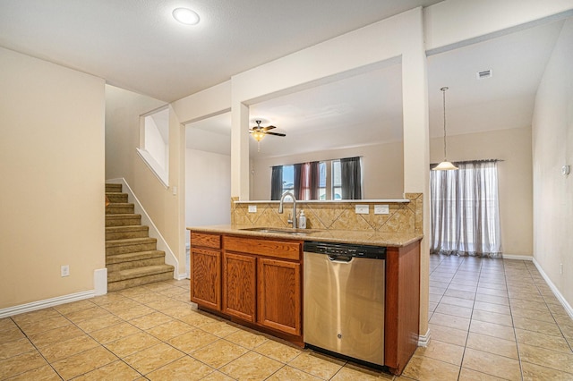 4216 Bridgestone Dr, Fort Worth, TX 76123 - kitchen with stainless steel dishwasher, a sink, light tile patterned flooring, tasteful backsplash, and brown cabinets