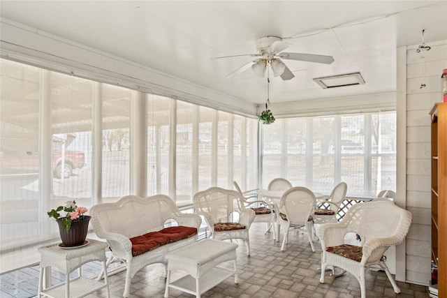 sunroom featuring ceiling fan