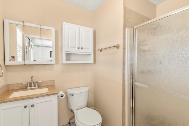 bathroom with vanity, an enclosed shower, and toilet