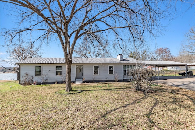 back of property featuring a lawn and a carport