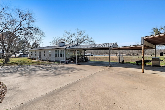 view of parking / parking lot featuring a carport