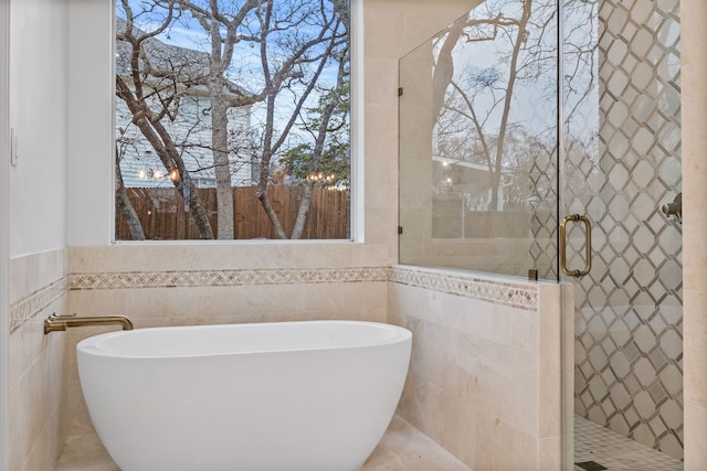 bathroom featuring a bathtub and tile walls