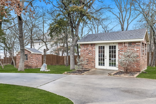 exterior space with an outdoor structure and a lawn