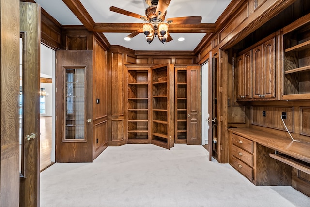 carpeted office with ceiling fan, wooden walls, and beamed ceiling