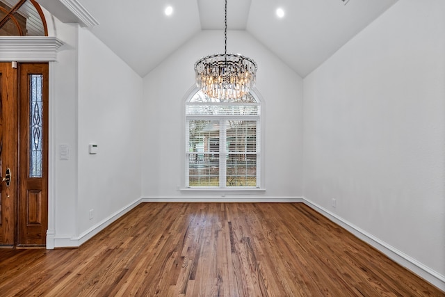 interior space with an inviting chandelier, hardwood / wood-style flooring, and vaulted ceiling