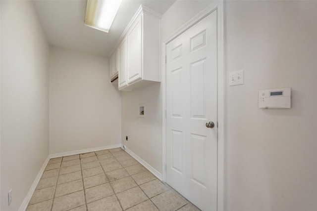 laundry room featuring cabinets, hookup for a washing machine, and light tile patterned floors