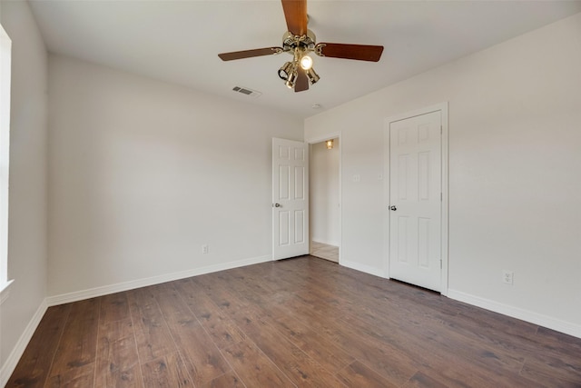 empty room with ceiling fan and dark hardwood / wood-style floors