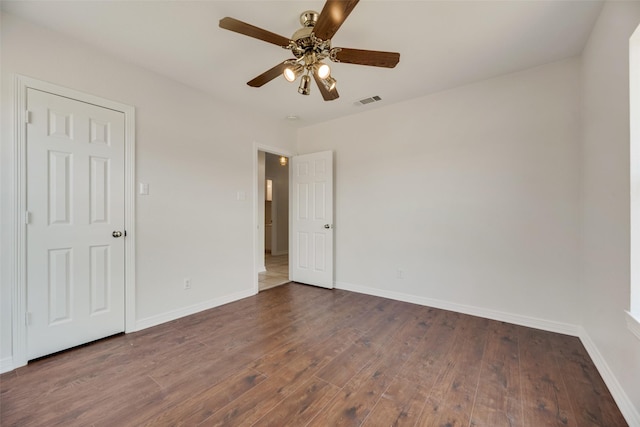 unfurnished room featuring ceiling fan and dark hardwood / wood-style flooring