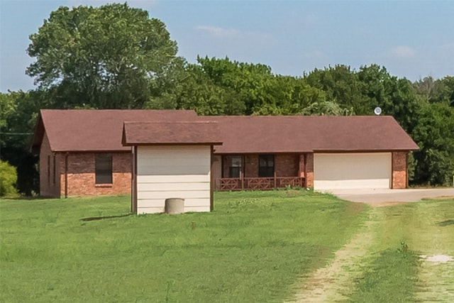 ranch-style home with a garage and a front yard