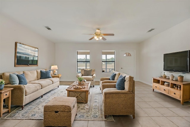 living room featuring light tile patterned floors and ceiling fan