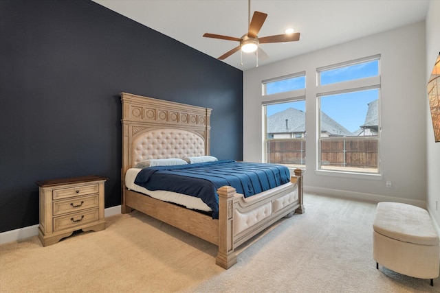 bedroom featuring ceiling fan and light carpet