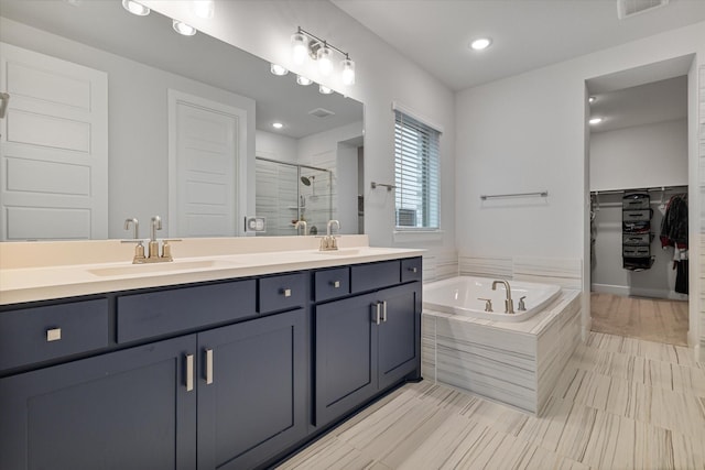 bathroom featuring vanity and plus walk in shower