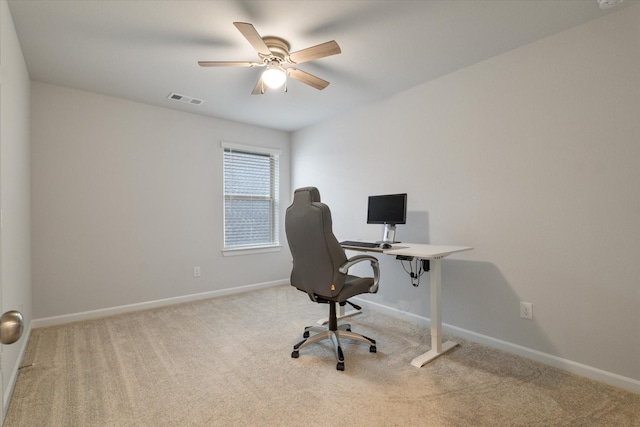 office space featuring light carpet and ceiling fan