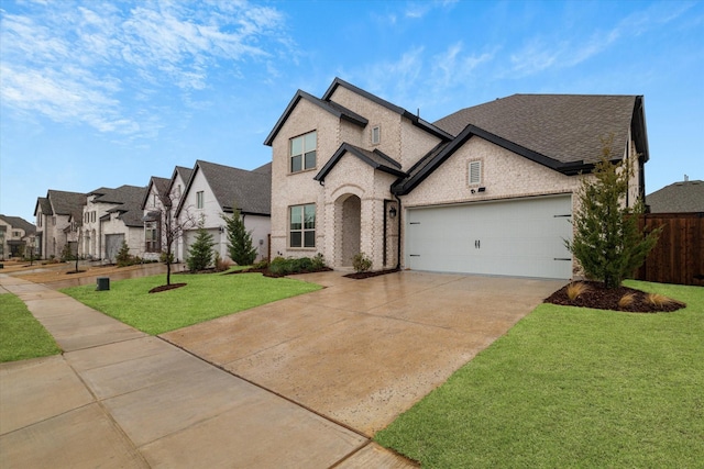 french provincial home with a garage and a front lawn