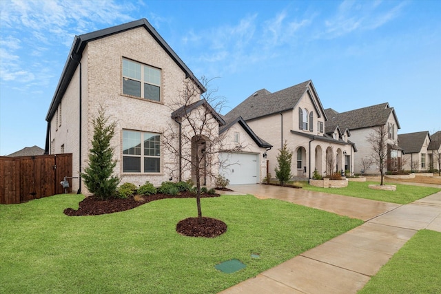 view of front of house with a front lawn, fence, a garage, and driveway