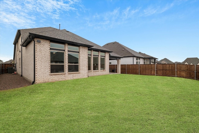 rear view of property featuring a lawn