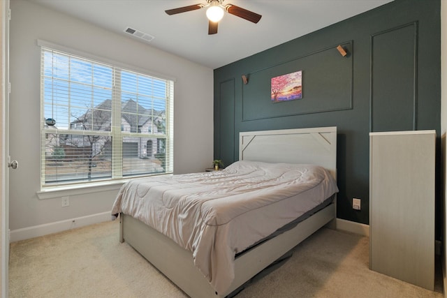 bedroom with ceiling fan and light carpet