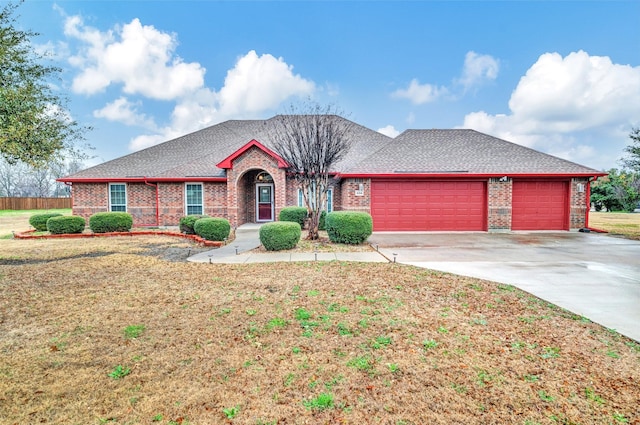 single story home featuring a front yard and a garage