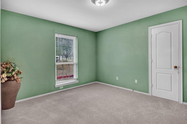 unfurnished room featuring light colored carpet