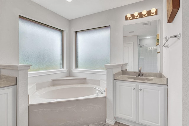 bathroom featuring shower with separate bathtub and vanity