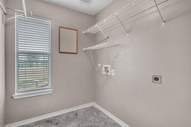 824 Rolling Meadow Dr, Lavon, TX 75166 - laundry area with hookup for an electric dryer, hookup for a washing machine, baseboards, and marble look tile flooring