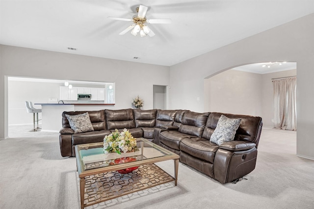 living room featuring light carpet and ceiling fan