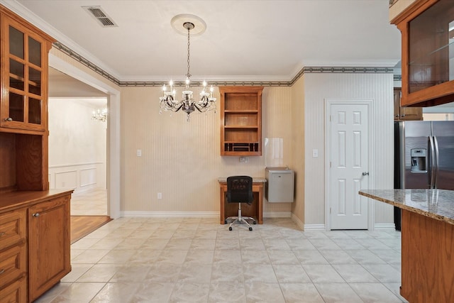 kitchen featuring stainless steel fridge, ornamental molding, light stone countertops, decorative light fixtures, and a chandelier