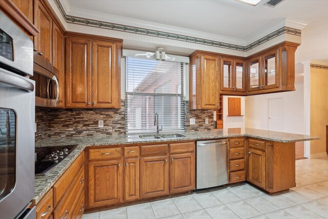 kitchen featuring crown molding, appliances with stainless steel finishes, kitchen peninsula, and sink