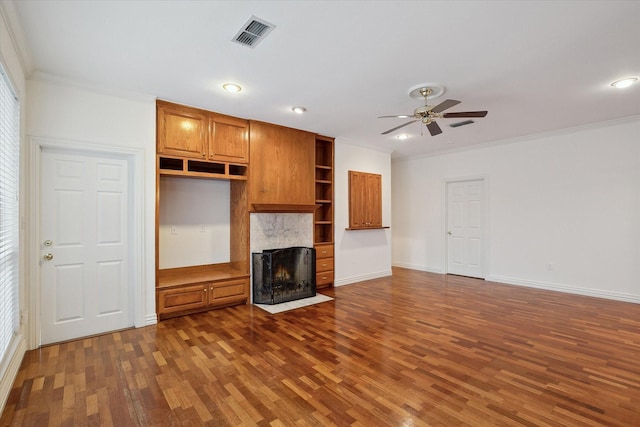 unfurnished living room with dark hardwood / wood-style flooring, ornamental molding, and ceiling fan