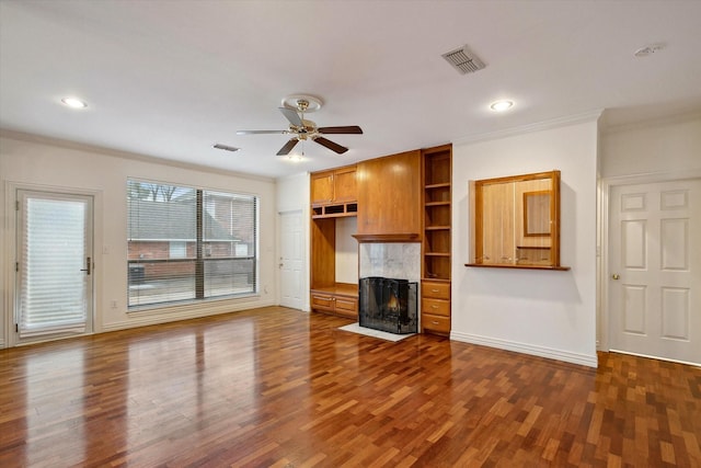 unfurnished living room with crown molding, ceiling fan, and dark hardwood / wood-style flooring