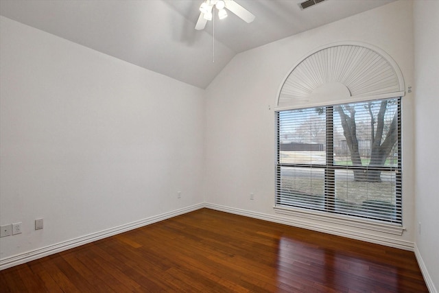 spare room featuring wood-type flooring, vaulted ceiling, and ceiling fan