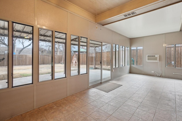 unfurnished sunroom featuring plenty of natural light and a wall mounted air conditioner