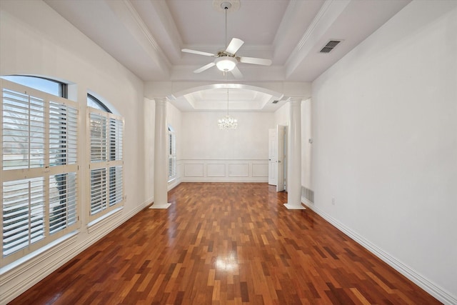 spare room featuring a tray ceiling, visible vents, and ornate columns